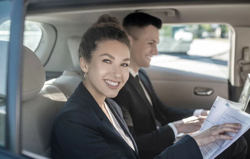Business couple in a car service vehicle