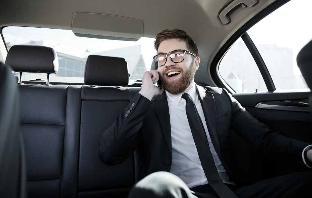 Smiling-bearded-business-man-in-eyeglasses-talking-on-cell-phone-during-his-shanghai-airport-transfer