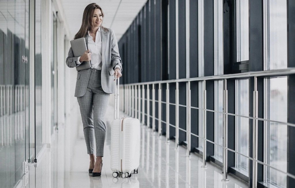 Businesswoman with travel luggage at airport