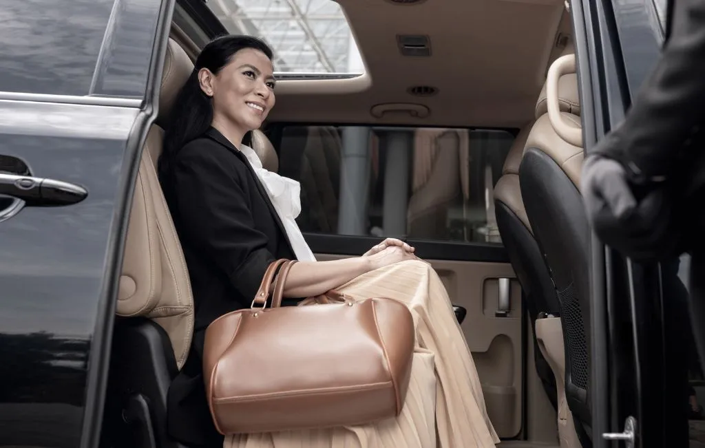chauffeur service female client inside limousine