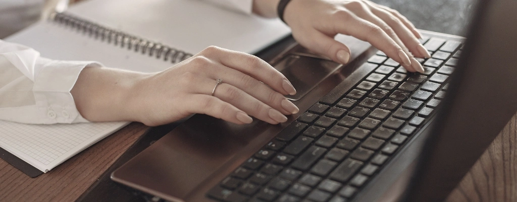 client booking a ride online using brown laptop