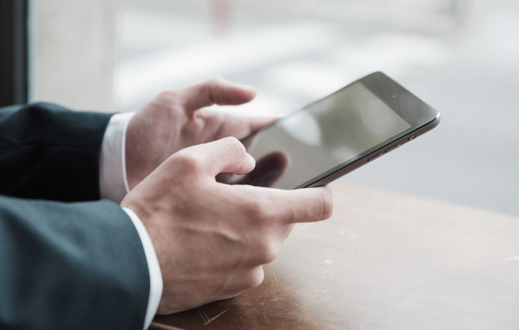 man booking a cruise transfer through his phone