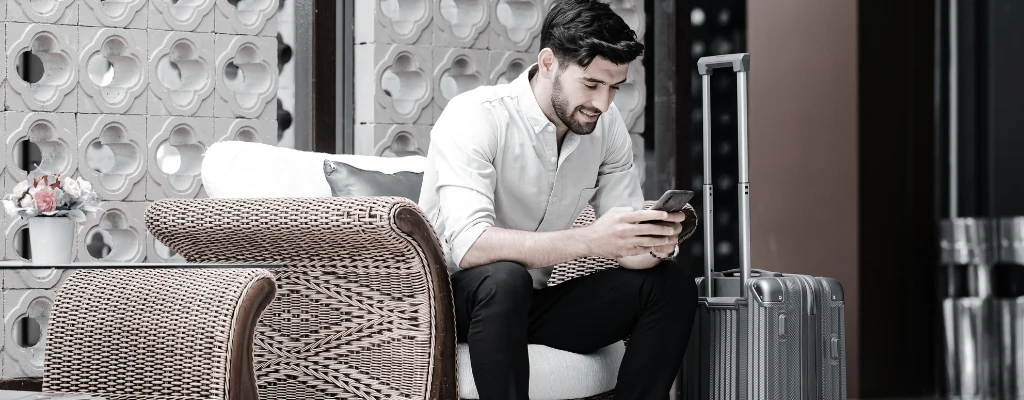 business owner sitting with phone in a hotel