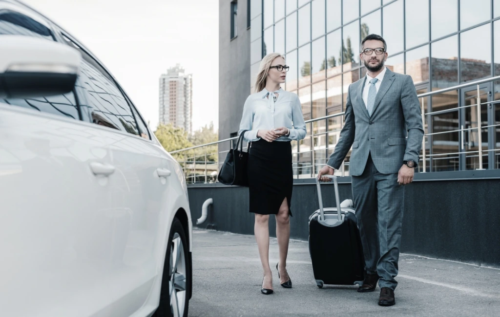 business people with luggage walking to their limo chauffeur service