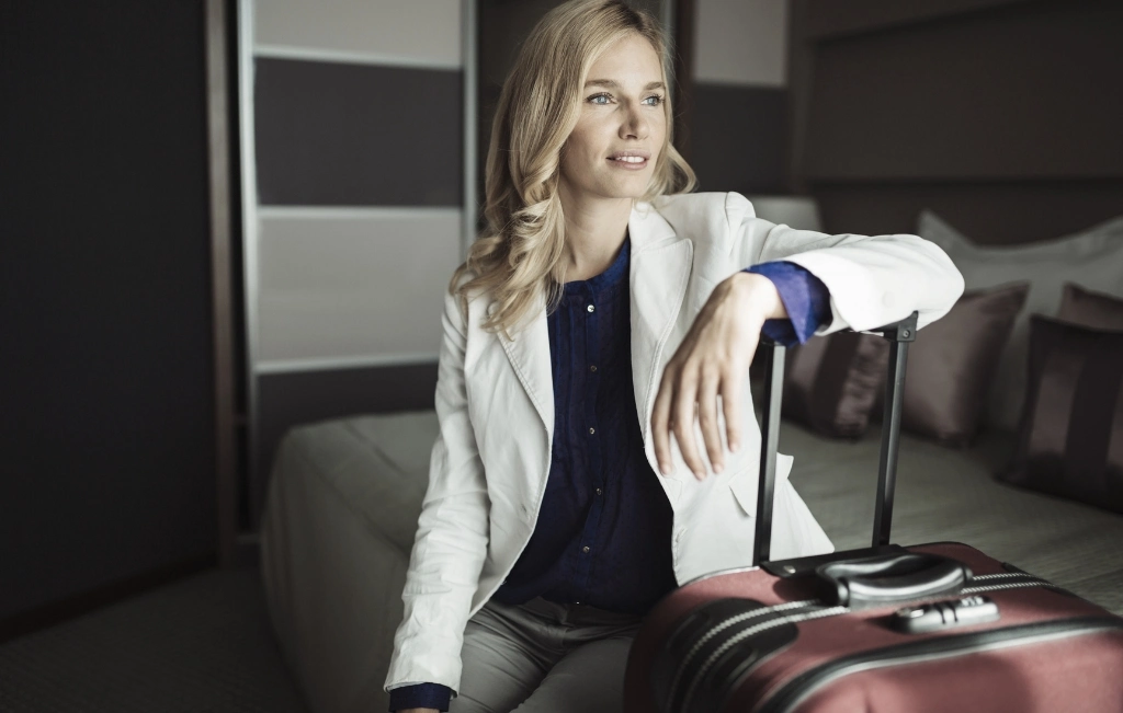 businesswoman with her luggage in hotel room