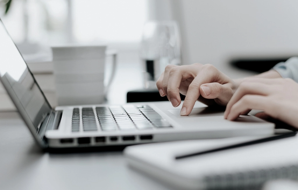 hands on laptop while booking a cruise terminal transfer