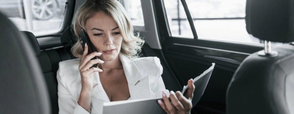 Woman inside car during airport to airport transfer