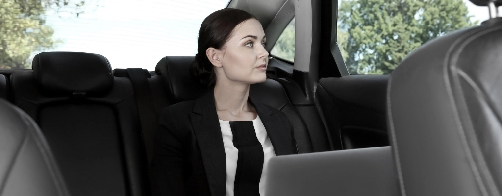 woman inside car sitting comfortably during airport limousine service