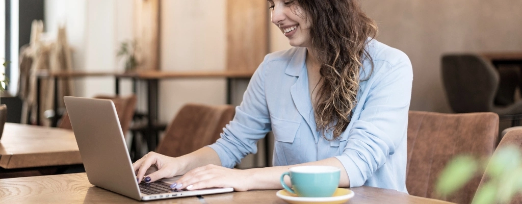 woman on laptop booking an airport limousine online