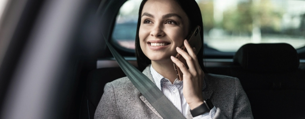 woman on the phone during airport-to-airport transfer service