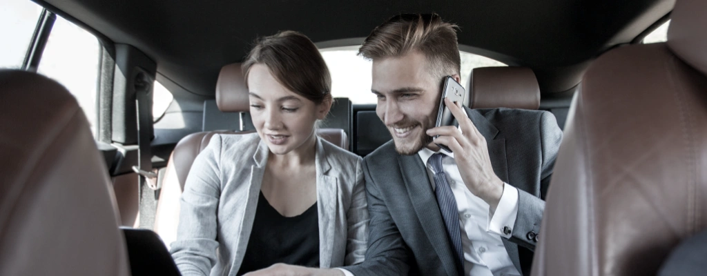 clients in backseat of transfer service vehicle